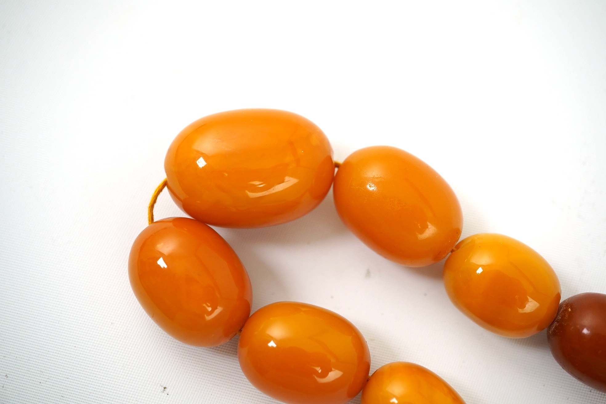 A single strand graduated oval amber bead necklace